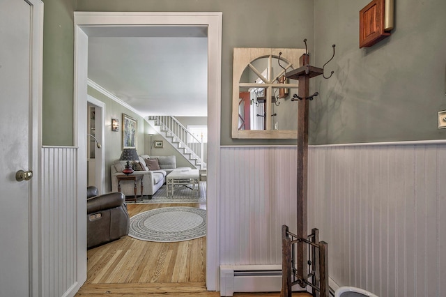 23 S Sixth St, Locust Valley, NY 11560 - hall with wainscoting, wood finished floors, stairs, and ornamental molding