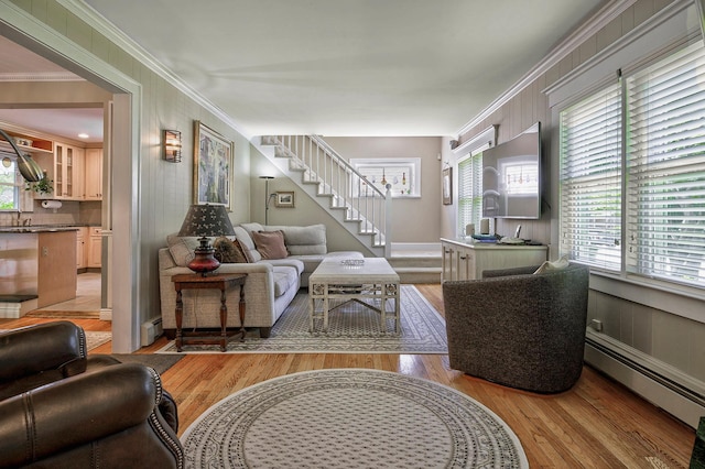 23 S Sixth St, Locust Valley, NY 11560 - living area featuring baseboard heating, stairway, wood finished floors, plenty of natural light, and ornamental molding