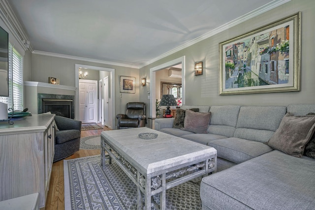 23 S Sixth St, Locust Valley, NY 11560 - living room featuring wood finished floors, a premium fireplace, crown molding, and a wall unit AC