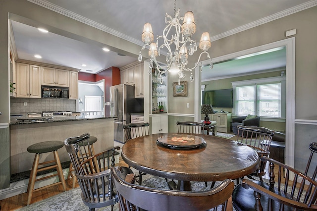 23 S Sixth St, Locust Valley, NY 11560 - dining room featuring a chandelier, wood finished floors, and crown molding