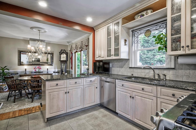 23 S Sixth St, Locust Valley, NY 11560 - kitchen with stainless steel dishwasher, a peninsula, a chandelier, plenty of natural light, and ornamental molding