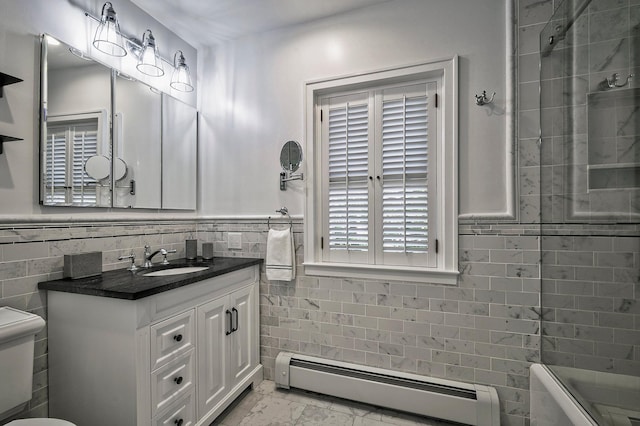 23 S Sixth St, Locust Valley, NY 11560 - bathroom with baseboard heating, vanity, tile walls, marble finish floors, and toilet