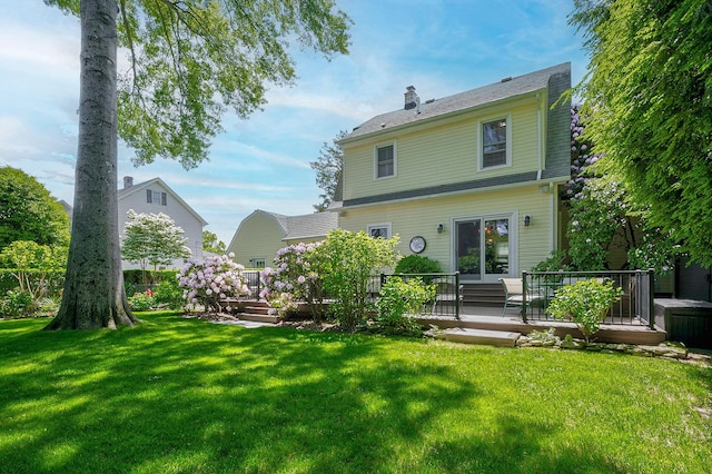 23 S Sixth St, Locust Valley, NY 11560 - rear view of house with a wooden deck, a chimney, and a yard