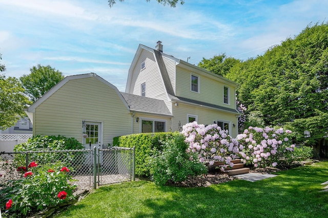 23 S Sixth St, Locust Valley, NY 11560 - rear view of property with a gambrel roof, a chimney, and a gate