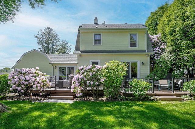 23 S Sixth St, Locust Valley, NY 11560 - back of house featuring a chimney, a deck, and a lawn
