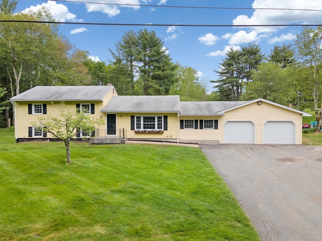323 Harris Rd, Monticello, NY 12701 - tri-level home with an attached garage, asphalt driveway, a front yard, and view of scattered trees