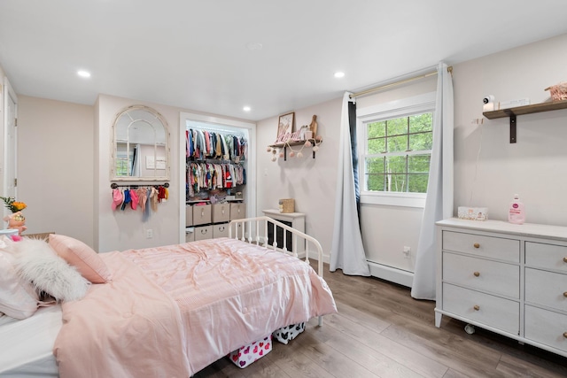 323 Harris Rd, Monticello, NY 12701 - bedroom with baseboard heating, wood finished floors, recessed lighting, and a closet