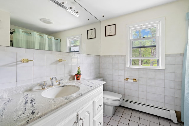 323 Harris Rd, Monticello, NY 12701 - full bathroom featuring baseboard heating, tile walls, tile patterned floors, vanity, and toilet