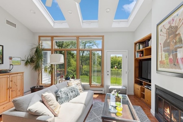 43 Hill St, Wading River, NY 11792 - tiled living room with a skylight, a baseboard heating unit, a fireplace with flush hearth, and vaulted ceiling