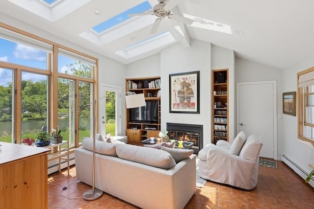 43 Hill St, Wading River, NY 11792 - living area with light tile patterned floors, a skylight, beamed ceiling, a glass covered fireplace, and high vaulted ceiling