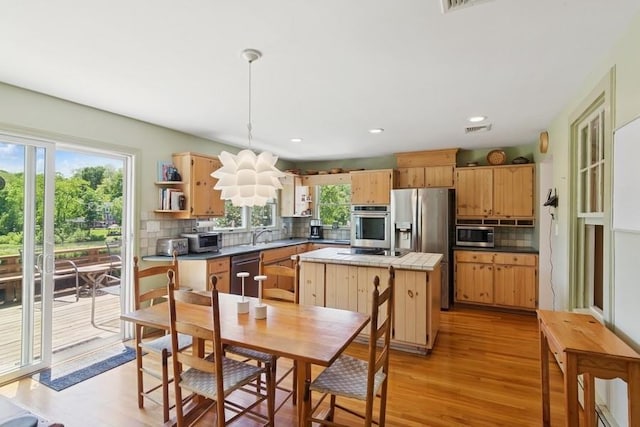 43 Hill St, Wading River, NY 11792 - kitchen with stainless steel appliances, plenty of natural light, light wood-style flooring, backsplash, and recessed lighting