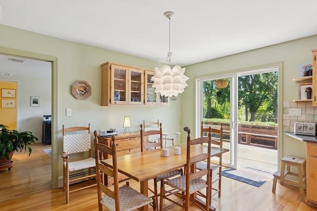43 Hill St, Wading River, NY 11792 - dining space with light wood-style flooring and a chandelier