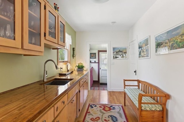 43 Hill St, Wading River, NY 11792 - kitchen featuring light wood-style floors, glass insert cabinets, and stone counters