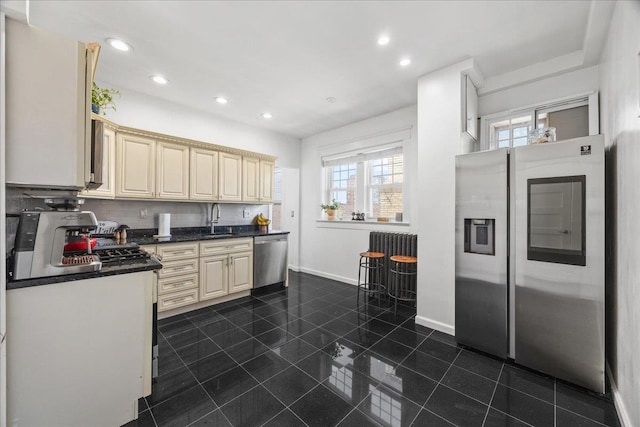 27 Locust Ave Unit 4N, New Rochelle, NY 10801 - kitchen with stainless steel appliances, dark countertops, recessed lighting, cream cabinets, and a sink
