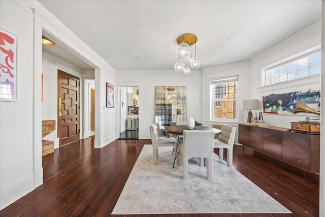 27 Locust Ave Unit 4N, New Rochelle, NY 10801 - dining space featuring a chandelier, hardwood / wood-style floors, and baseboards