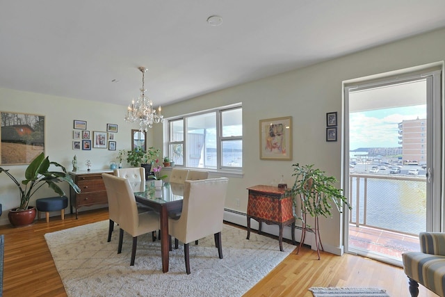 103 Gedney St Unit 2N, Nyack, NY 10960 - dining room featuring a chandelier, light wood finished floors, and a baseboard heating unit