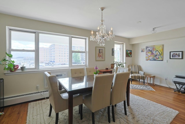 103 Gedney St Unit 2N, Nyack, NY 10960 - dining space with baseboard heating, a chandelier, and wood finished floors