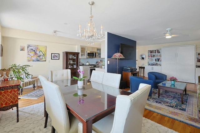 103 Gedney St Unit 2N, Nyack, NY 10960 - dining area with light wood-style floors, a chandelier, and a ceiling fan