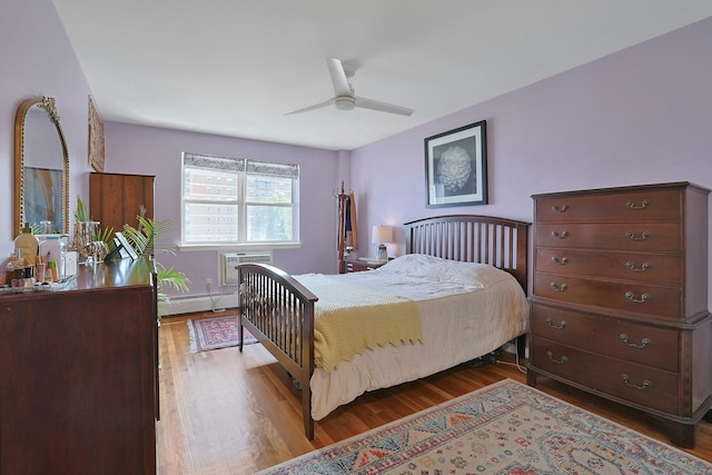 103 Gedney St Unit 2N, Nyack, NY 10960 - bedroom featuring baseboard heating, wood finished floors, and a wall mounted AC