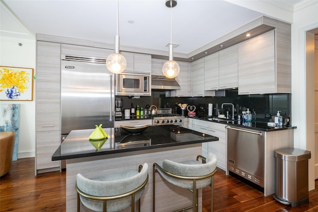 5 Renaissance Sq Unit 17B, White Plains, NY 10601 - kitchen with built in appliances, dark countertops, under cabinet range hood, a sink, and dark wood-style floors