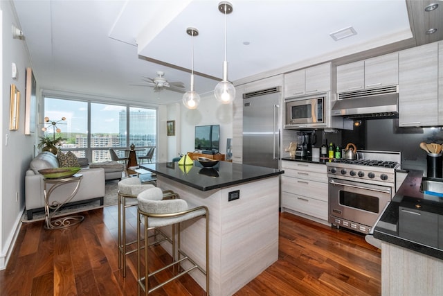 5 Renaissance Sq Unit 17B, White Plains, NY 10601 - kitchen with under cabinet range hood, built in appliances, ceiling fan, open floor plan, and dark countertops