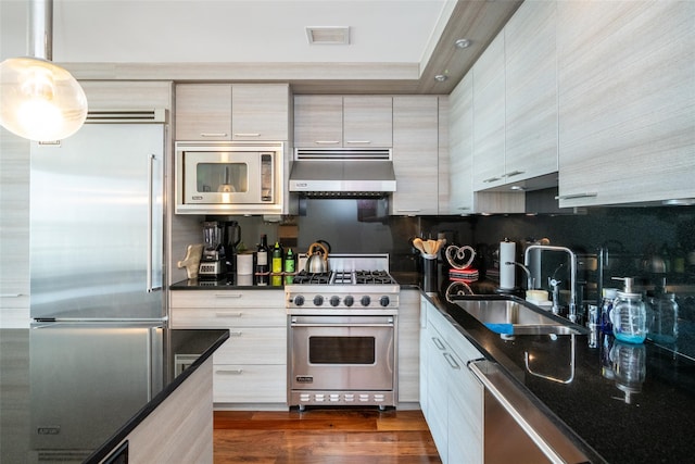 5 Renaissance Sq Unit 17B, White Plains, NY 10601 - kitchen featuring built in appliances, a sink, under cabinet range hood, decorative backsplash, and modern cabinets