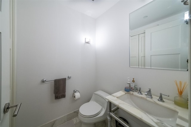 5 Renaissance Sq Unit 17B, White Plains, NY 10601 - half bath featuring vanity, toilet, baseboards, and marble finish flooring
