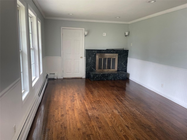 10 Kirby Ln, Central Islip, NY 11722 - unfurnished living room with baseboard heating, a premium fireplace, wood finished floors, a baseboard radiator, and wainscoting