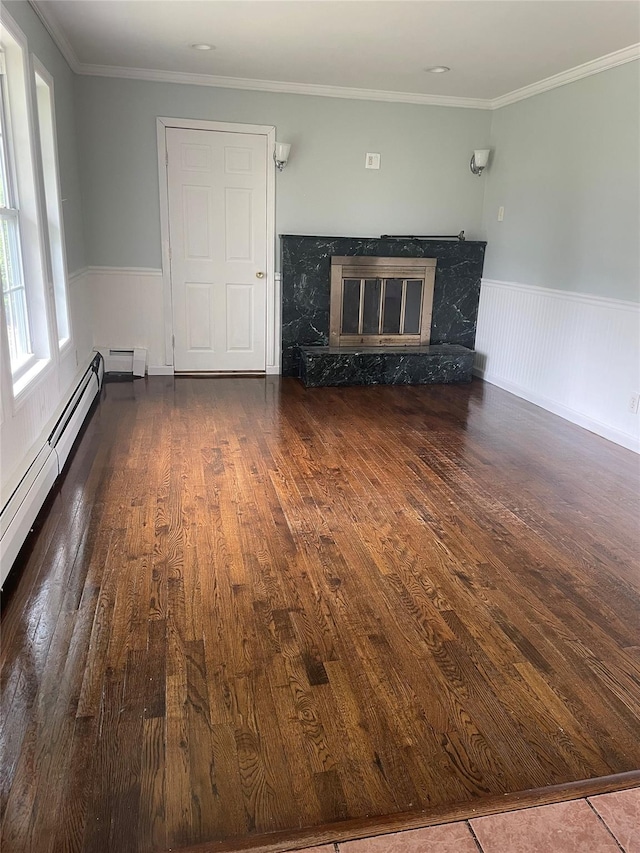 10 Kirby Ln, Central Islip, NY 11722 - unfurnished living room featuring a fireplace, wood-type flooring, wainscoting, and ornamental molding