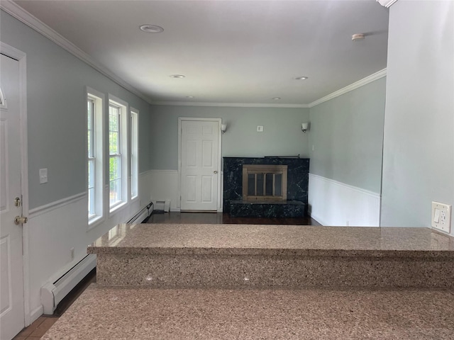 10 Kirby Ln, Central Islip, NY 11722 - stairway featuring a baseboard radiator, baseboard heating, a high end fireplace, wainscoting, and ornamental molding
