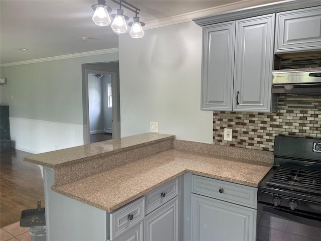 10 Kirby Ln, Central Islip, NY 11722 - kitchen featuring black gas stove, a peninsula, backsplash, crown molding, and range hood