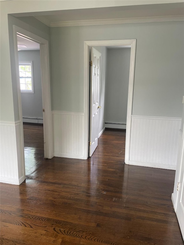 10 Kirby Ln, Central Islip, NY 11722 - unfurnished room with a baseboard radiator, a wainscoted wall, dark wood-style floors, and crown molding