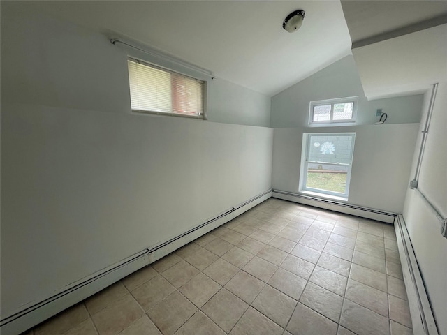 10 Kirby Ln, Central Islip, NY 11722 - empty room featuring a baseboard radiator, lofted ceiling, and light tile patterned flooring