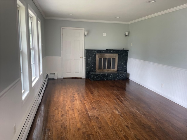 10 Kirby Ln, Central Islip, NY 11722 - unfurnished living room with a high end fireplace, a baseboard radiator, wood finished floors, wainscoting, and a baseboard heating unit