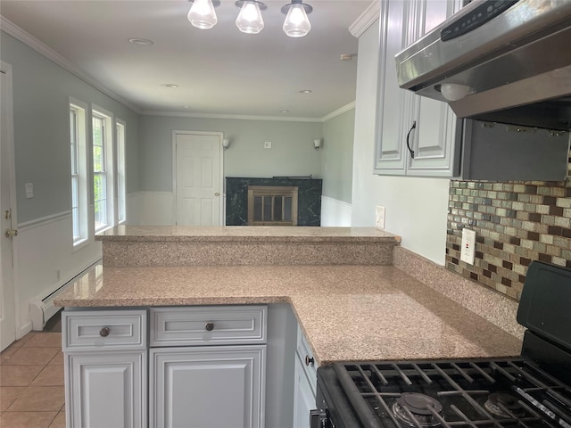 10 Kirby Ln, Central Islip, NY 11722 - kitchen featuring black gas range oven, under cabinet range hood, a peninsula, a baseboard radiator, and decorative backsplash