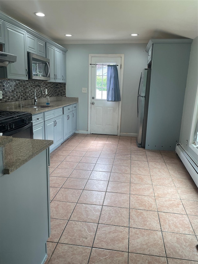10 Kirby Ln, Central Islip, NY 11722 - kitchen with stainless steel appliances, a sink, tasteful backsplash, under cabinet range hood, and light tile patterned floors