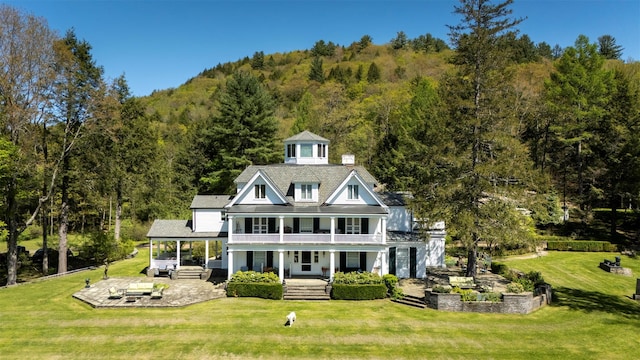 390 Erpf Rd, Arkville, NY 12406 - view of front of home with a porch, a wooded view, a front lawn, and a patio