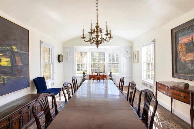 390 Erpf Rd, Arkville, NY 12406 - dining space with a chandelier, vaulted ceiling, wood finished floors, radiator heating unit, and baseboards
