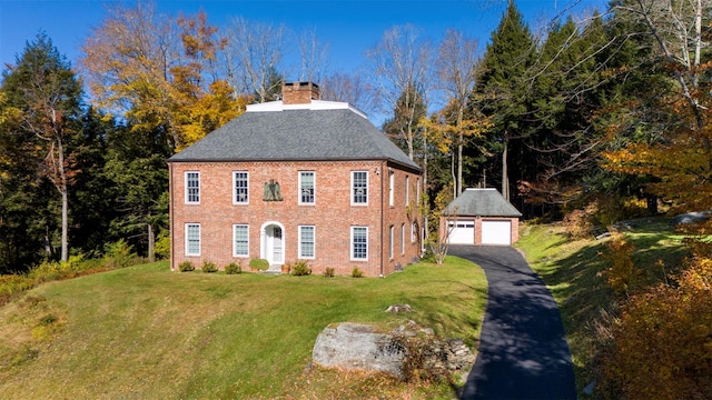 390 Erpf Rd, Arkville, NY 12406 - view of front of home featuring a detached garage, an outbuilding, a chimney, a front lawn, and brick siding