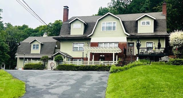 55 Buckberg Mountain Rd, Tomkins Cove, NY 10986 - view of front of home featuring a chimney, a gambrel roof, and covered porch