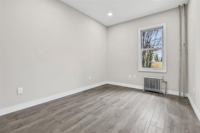 305 Union Ave, New Rochelle, NY 10801 - spare room with radiator heating unit, wood finished floors, baseboards, and recessed lighting