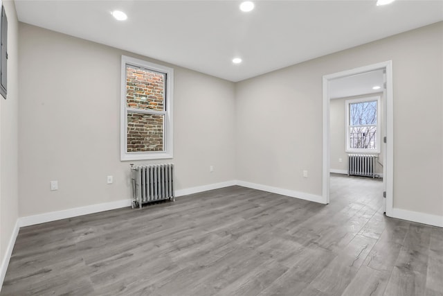 305 Union Ave, New Rochelle, NY 10801 - empty room with radiator, wood finished floors, recessed lighting, and baseboards