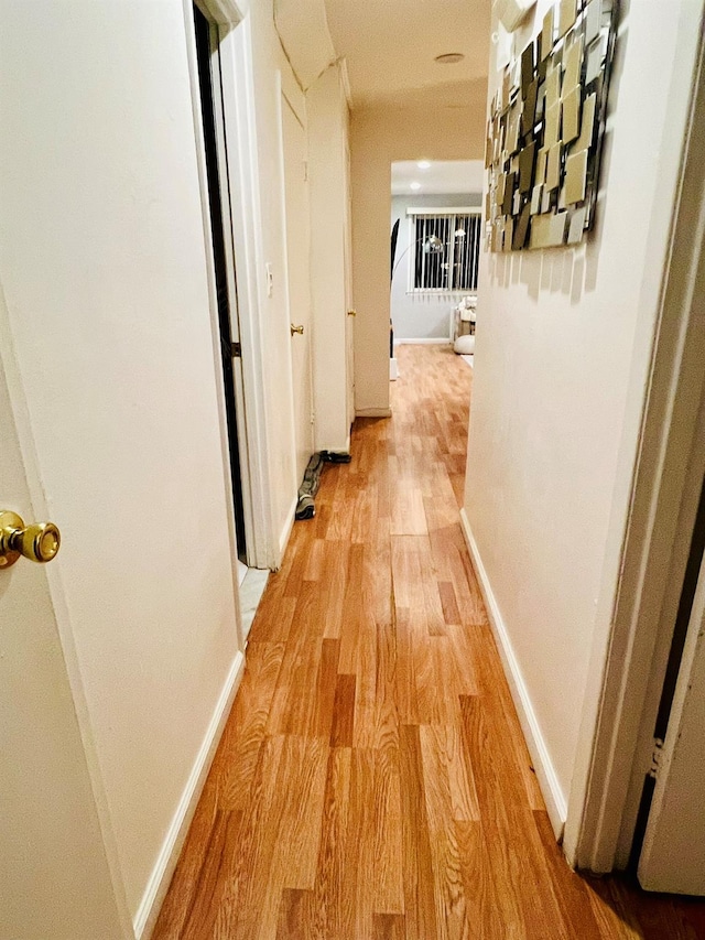 5-41 117th St, College Point, NY 11356 - hall with light wood-type flooring and baseboards