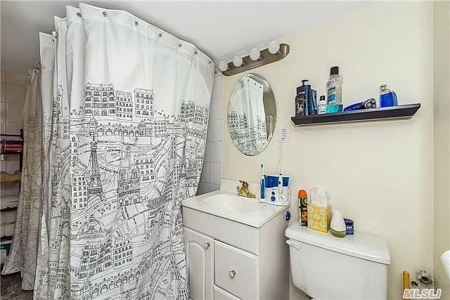 5-41 117th St, College Point, NY 11356 - bathroom featuring toilet, vanity, and a shower with shower curtain