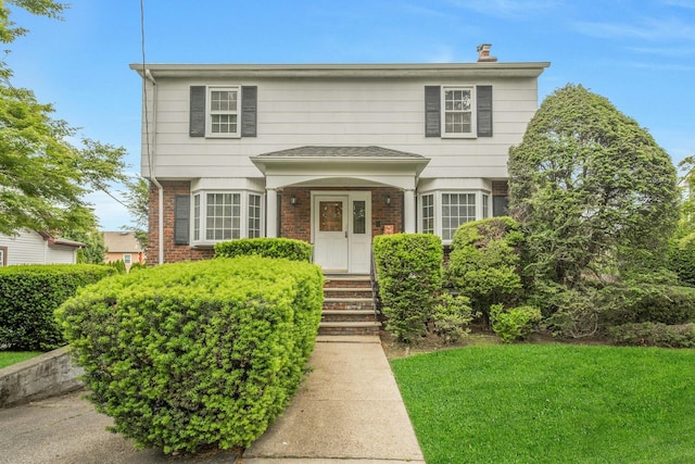 115 Fowler Ave, Yonkers, NY 10701 - traditional-style home featuring brick siding and a front lawn