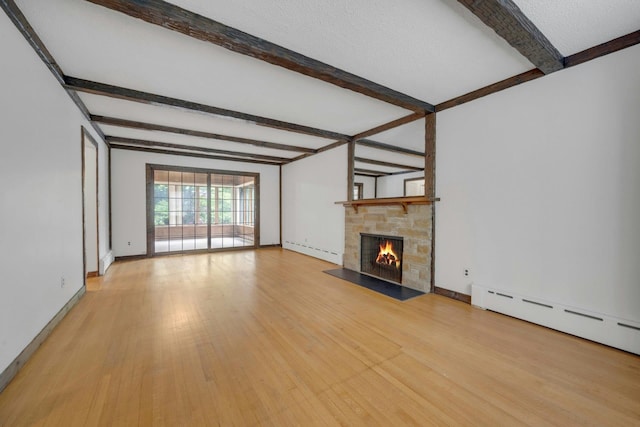 115 Fowler Ave, Yonkers, NY 10701 - unfurnished living room featuring baseboard heating, beam ceiling, light wood-type flooring, a stone fireplace, and baseboards
