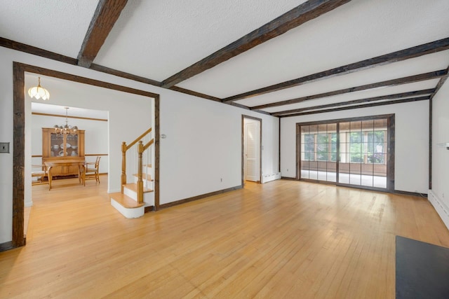 115 Fowler Ave, Yonkers, NY 10701 - unfurnished living room with a chandelier, light wood-type flooring, stairway, beam ceiling, and baseboards