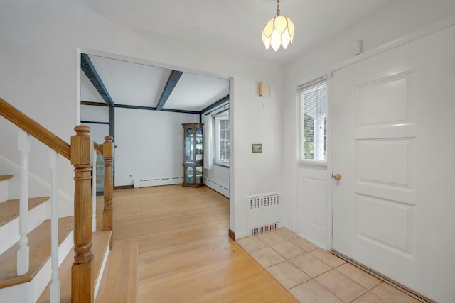 115 Fowler Ave, Yonkers, NY 10701 - entryway with radiator heating unit, a baseboard radiator, stairs, and light wood finished floors