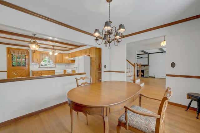 115 Fowler Ave, Yonkers, NY 10701 - dining space with a chandelier, a baseboard heating unit, light wood-style floors, crown molding, and baseboards