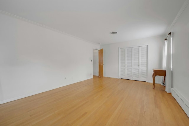 115 Fowler Ave, Yonkers, NY 10701 - unfurnished bedroom featuring baseboard heating, ornamental molding, light wood-style floors, a closet, and baseboards